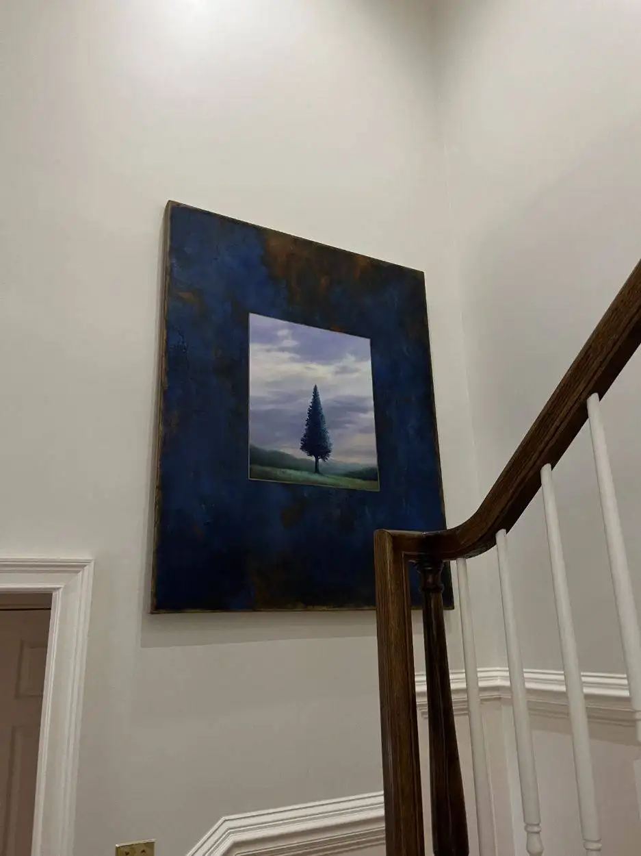 Pine tree painting hung in the stairwell